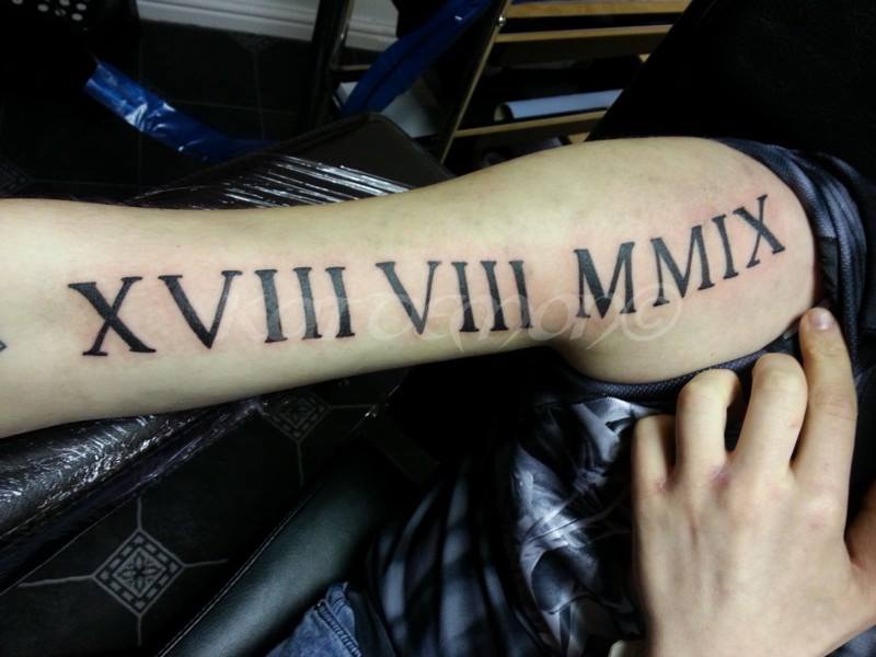 roman numerals arm tattoo